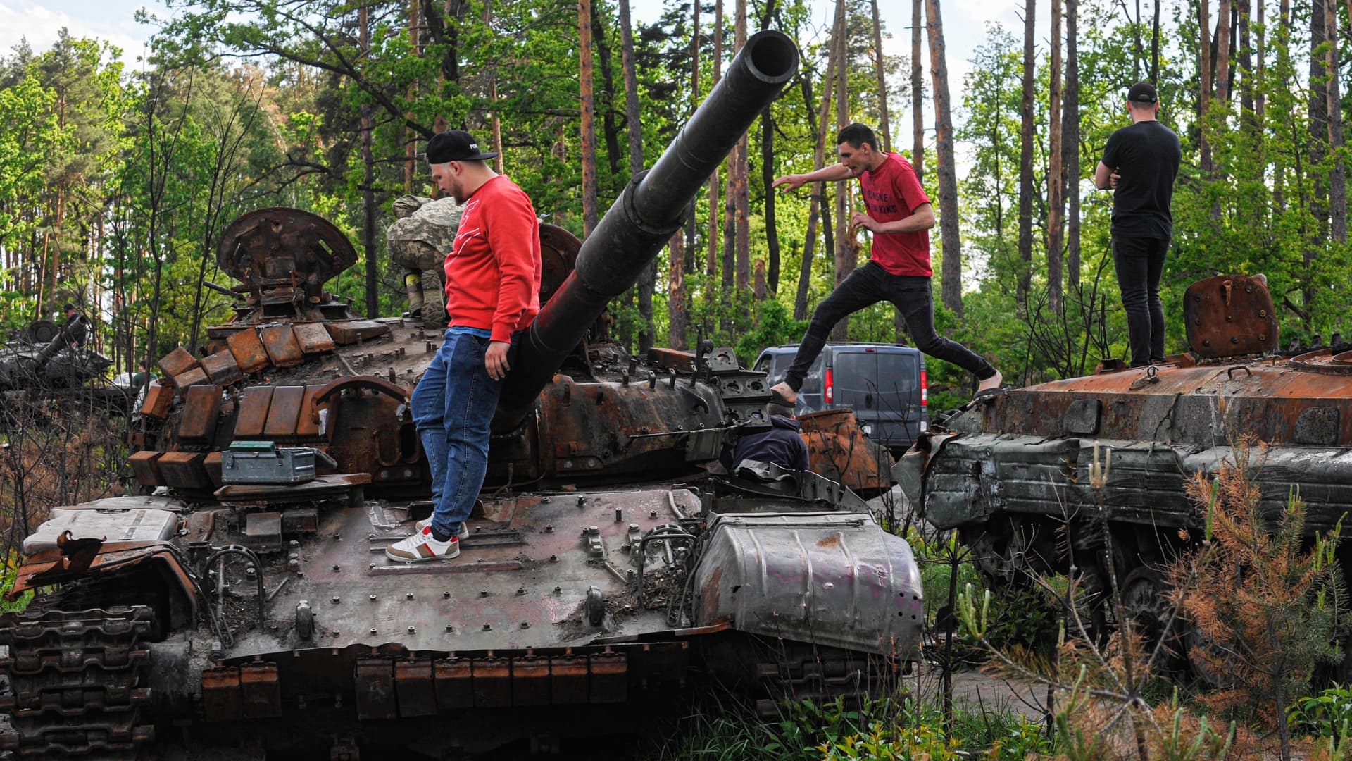 People are looking at the destroyed Russian military armored vehicles at Dmytrivka village near the Ukrainian capital Kyiv.