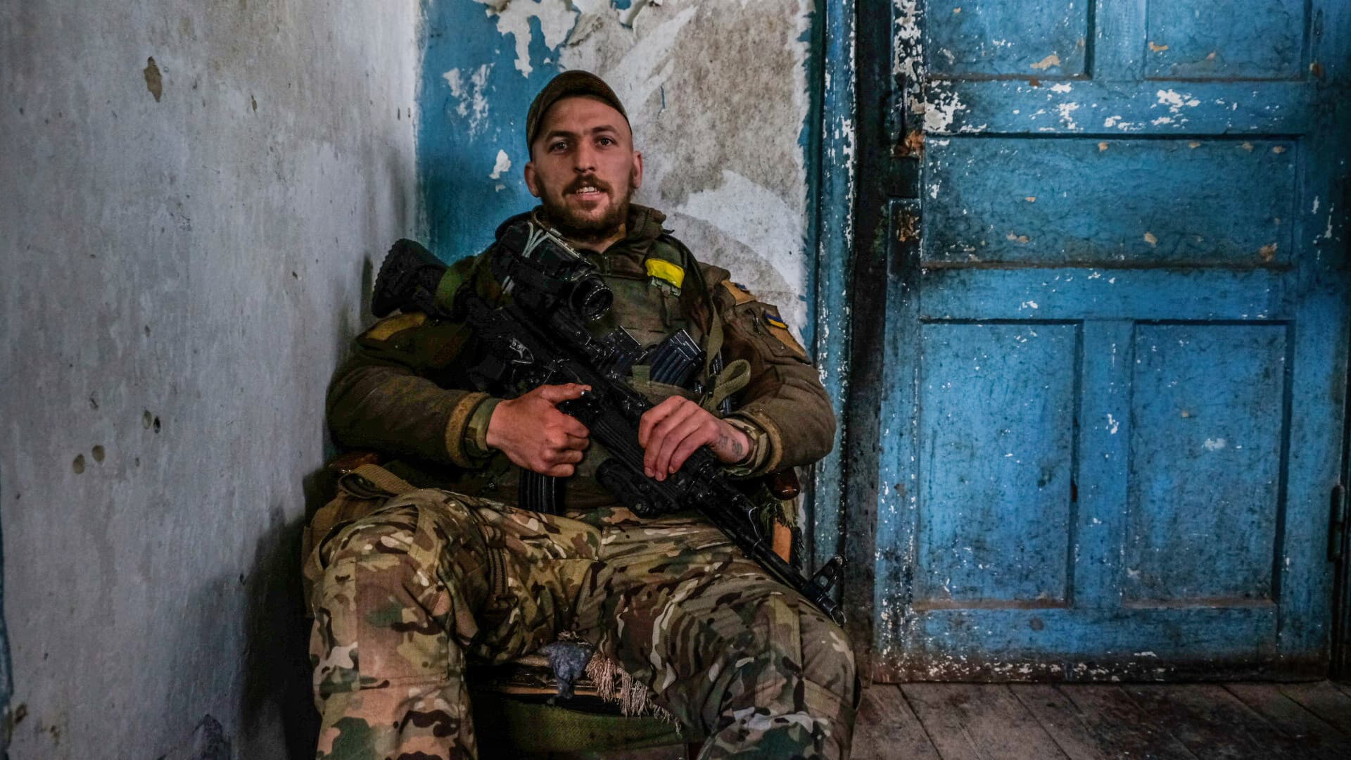 A soldier sitting at the entrance of the headquarter of the battalion. Soledar is a town in the Donetsk region, where it is being hammered by Russian artillery as it sits along the crucial road that leads out of besieged Severodonetsk.