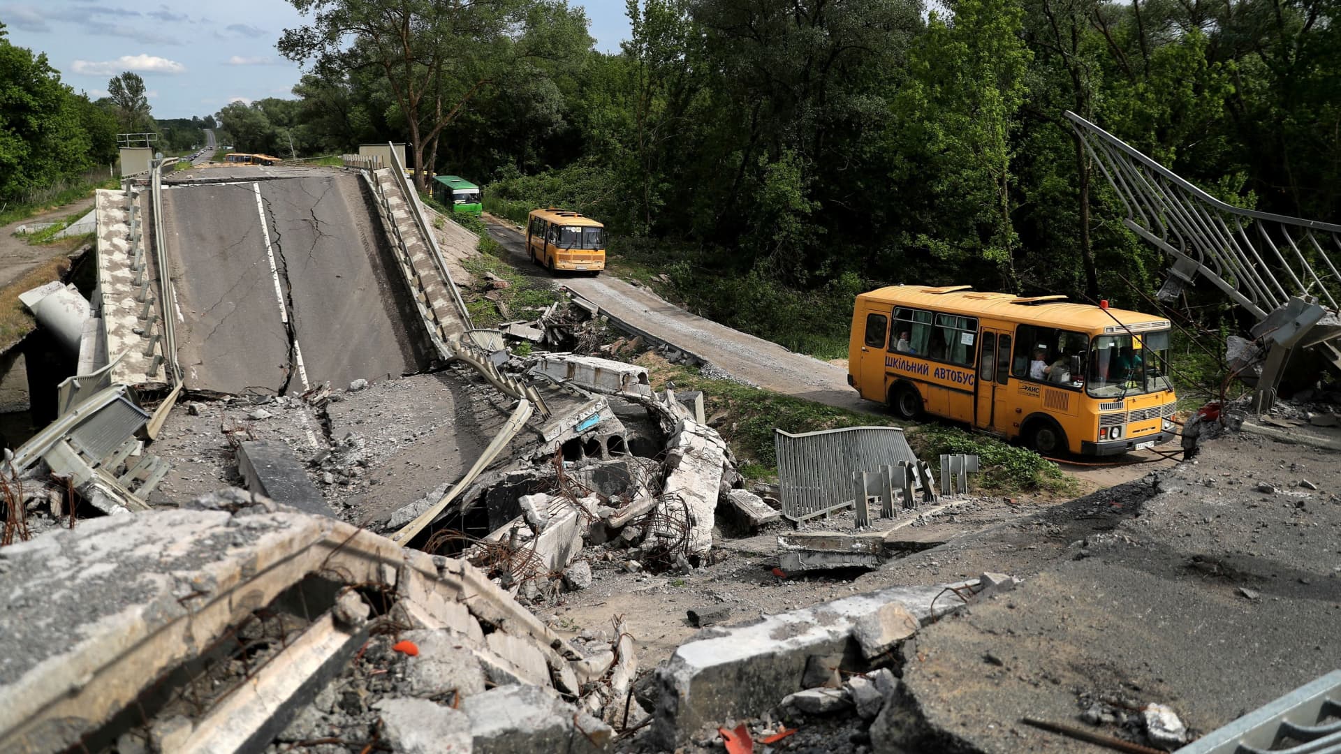 An evacuation convoy travels from Russian troop-occupied Kupiansk town, along a damaged road, amid Russia's attack on Ukraine, on the outskirts of Kharkiv, Ukraine May 30, 2022. 