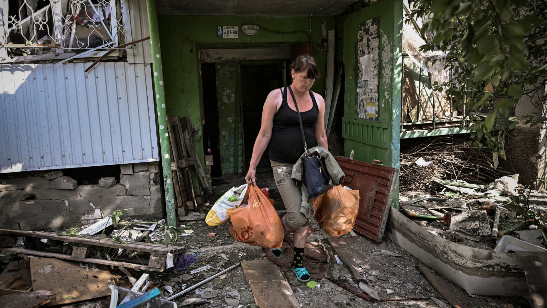 A woman walks out of a damaged appartment building after a strike in the city of Slovyansk at the eastern Ukrainian region of Donbas on May 31, 2022, amid Russian invasion of Ukraine.