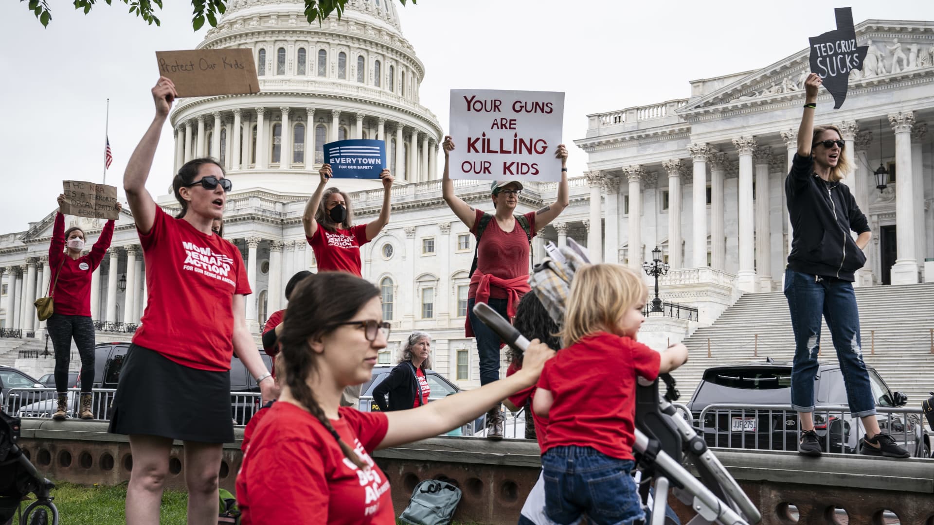 Activists listen as Senate Democrats speak during a news conference demanding action on gun control legislation after a gunman killed 19 children and two teachers in a Texas elementary school this week, on Capitol Hill on Thursday, May 26, 2022 in Washington, DC.