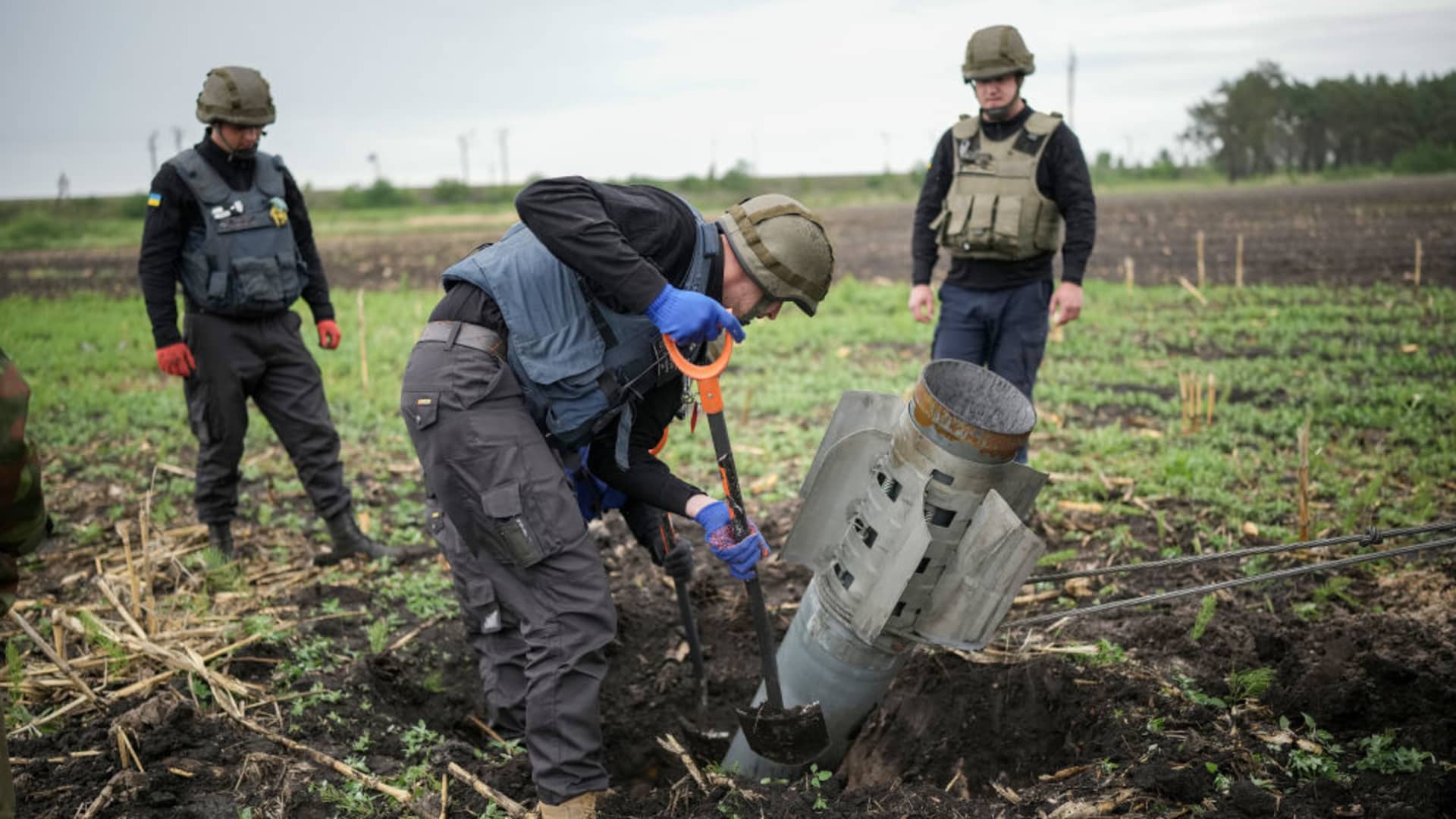 Bomb disposal experts from the Ukrainian State Emergency Service make safe a Russian BM-30 Smerch rocket and remove it from a field on May 31, 2022 in Borodianka, Ukraine. 