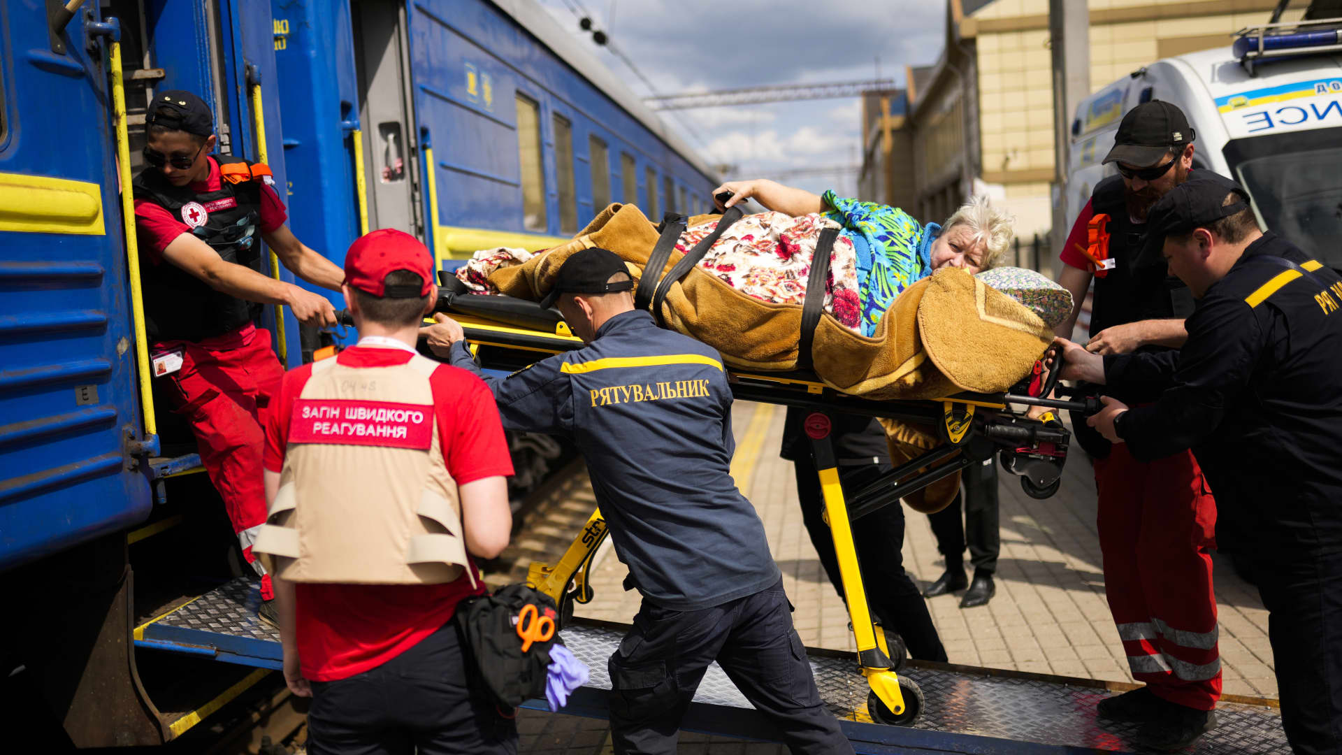 A patient is carried on a stretcher to board a medical evacuation train run by MSF (Doctors Without Borders) at the train station in Pokrovsk, eastern Ukraine, Sunday, May 29, 2022.