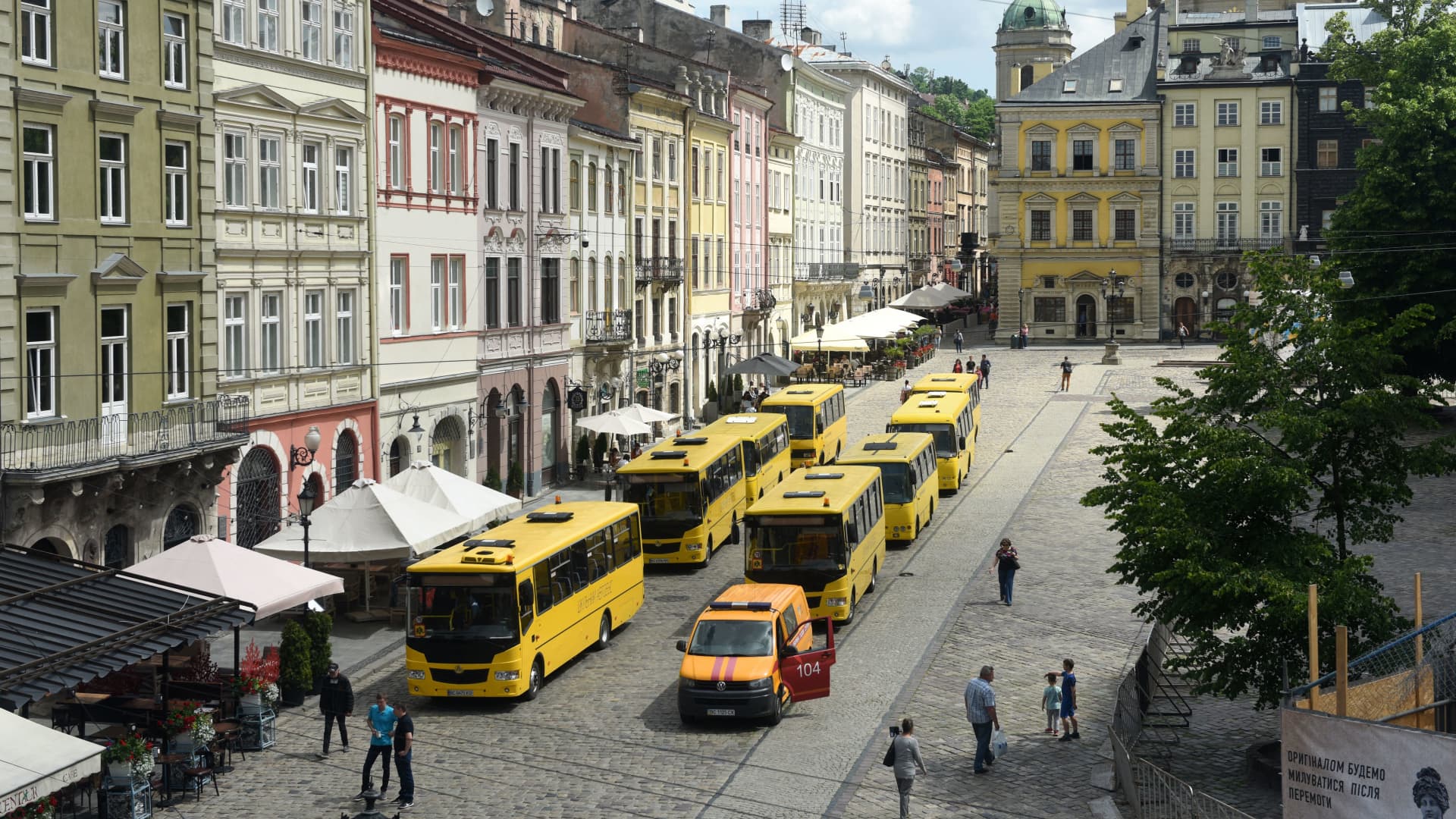 A general view shows empty yellow school busses where stuffed toys symbolizing each of 243 killed Ukrainian children are displayed on seats during an action marking the International Children's Day, in Lviv on June 1, 2022, amid the Russian invasion of Ukraine.