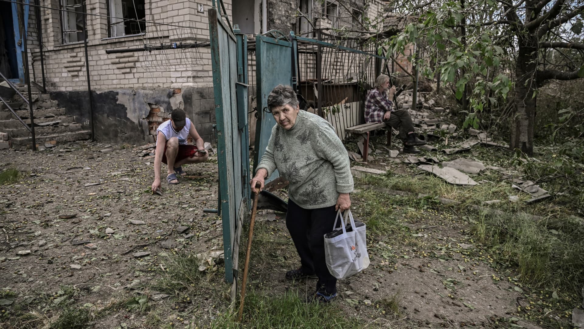 A man sits and smokes a cigarette in front of his destroyed house after a missile strike, which killed an old woman, in the city of Druzhkivka (also written Druzhkovka) in the eastern Ukrainian region of Donbas on June 5, 2022.