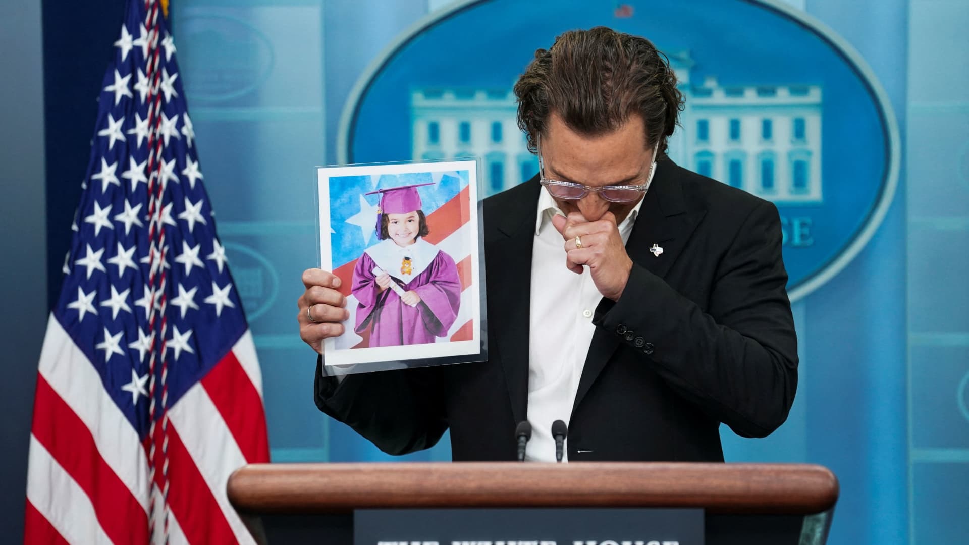 Actor Matthew McConaughey, a native of Uvalde, Texas as well as a father and a gun owner, becomes emotional as he holds up a picture of a young victim of the school shooting in Uvalde as he speaks to reporters about mass shootings in the United States during a press briefing at the White House in Washington, U.S., June 7, 2022. 