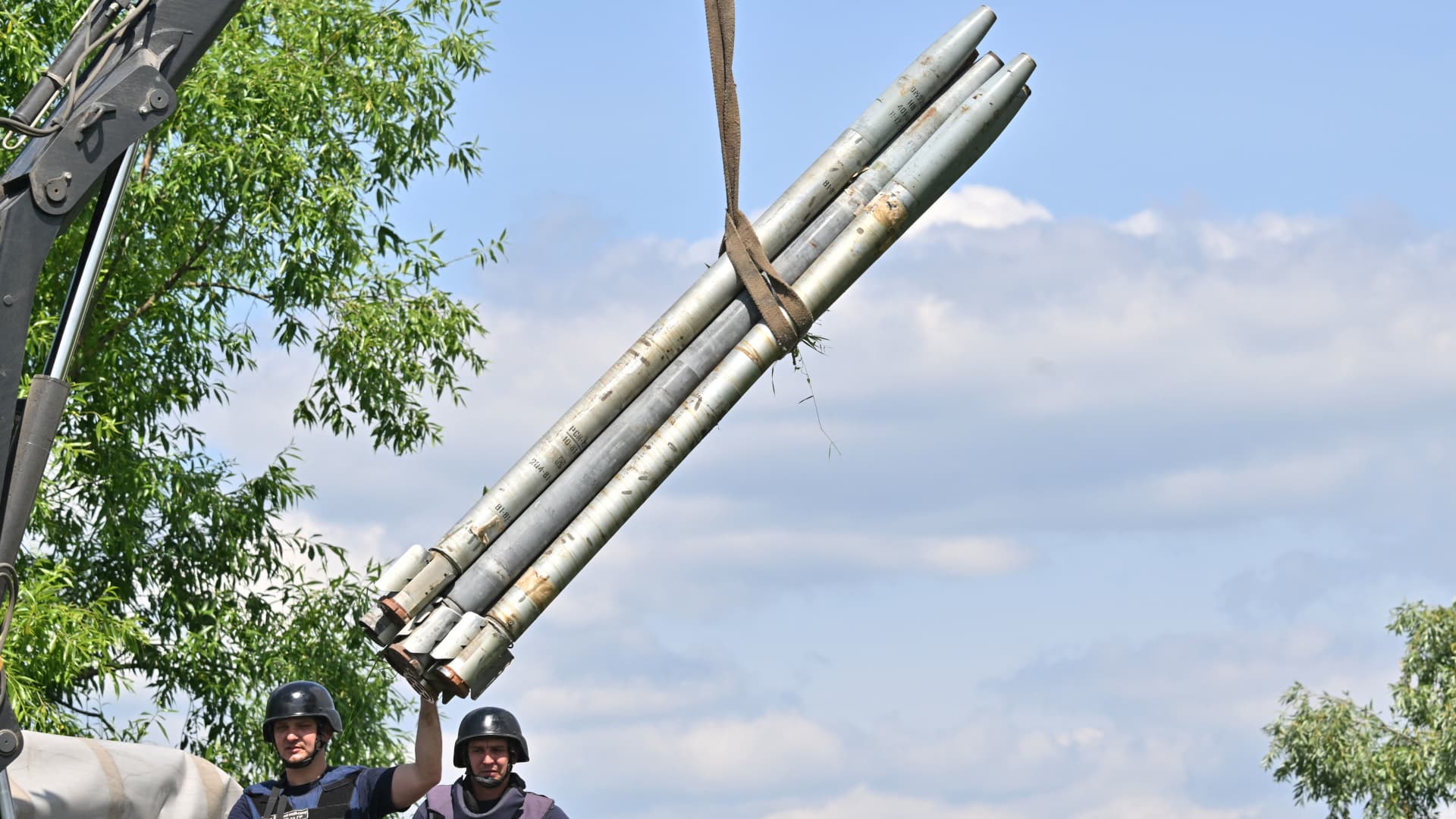 Ukrainian bomb disposal workers load unexploded ordnance in containers before transportation aboard a special vehicle during mine clearance work in the village of Yahidne, in the liberated territories of the Chernihiv region on June 7, 2022 amid the Russian invasion of Ukraine.