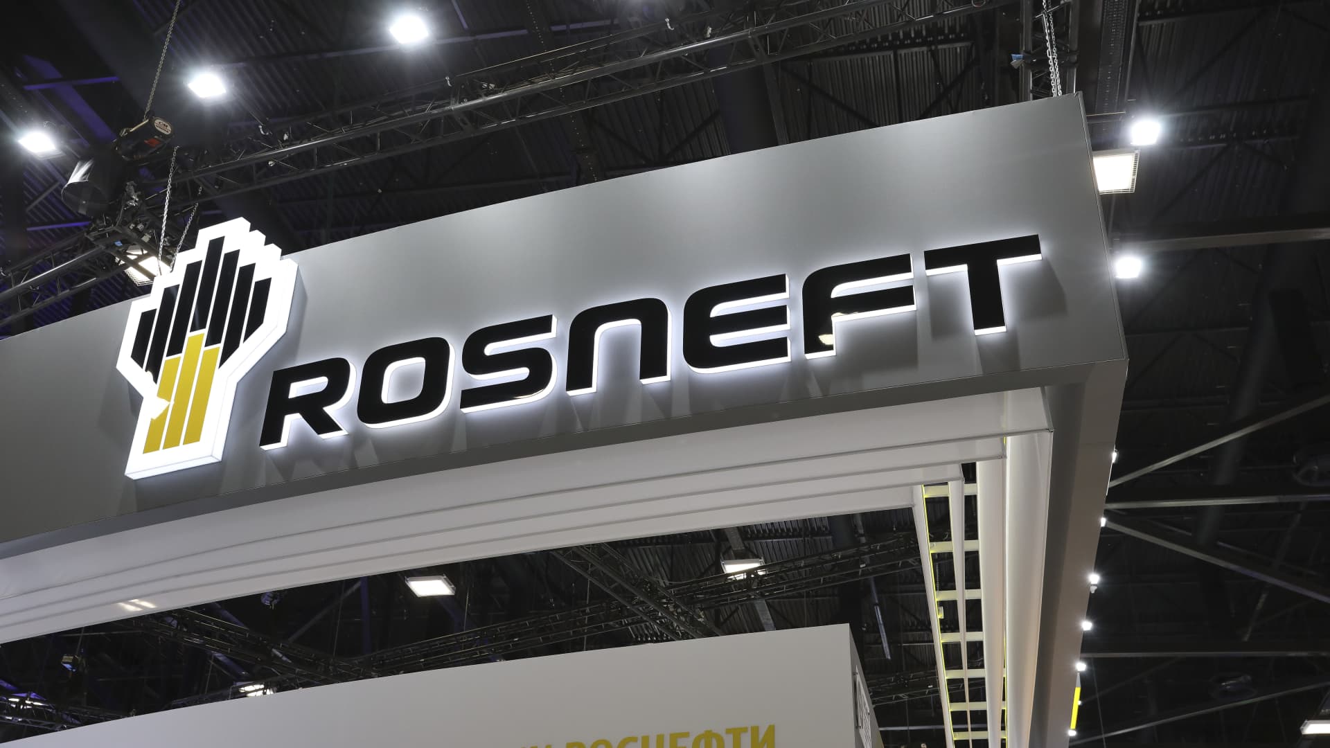 An illuminated logo sits on display above the Rosneft Oil Co. pavilion on June 5, 2019. Russia's Rosneft is holding back on signing new crude oil deals with two Indian state refiners, three sources with knowledge of the matter said, as it has committed sales to other customers.