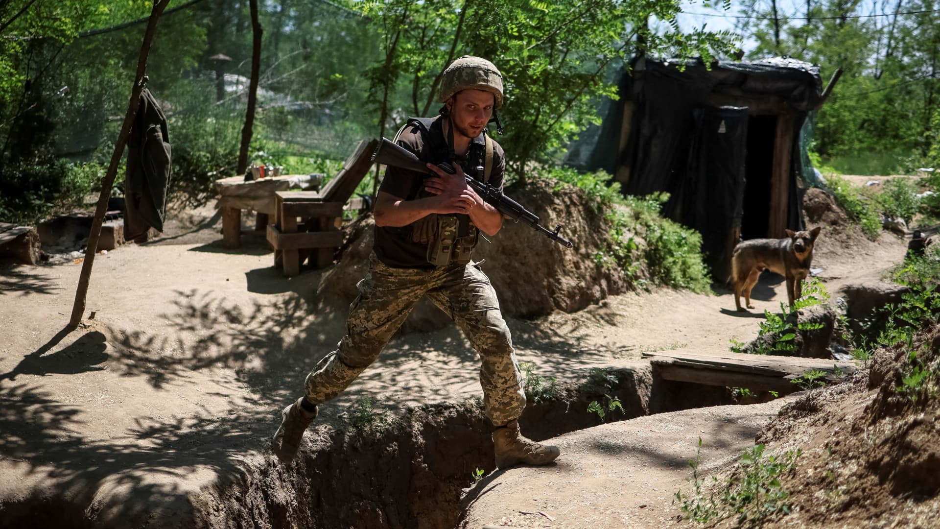 A Ukrainian service member walks at a position on the front line, amid Russia's attack on Ukraine, near the town of New York, Donetsk region, Ukraine June 9, 2022. 