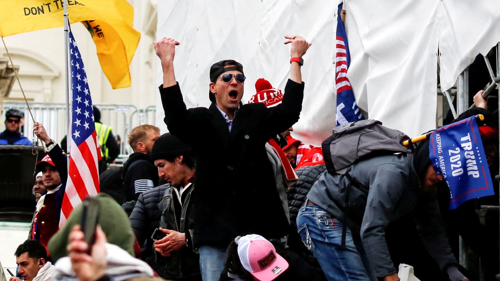 A man, identified as Ryan Kelley in a sworn statement by an FBI agent, gestures as supporters of U.S. President Donald Trump make their way past barriers at the U.S. Capitol during a protest against the certification of the 2020 U.S. presidential election results by the U.S. Congress, in Washington, U.S., January 6, 2021. 