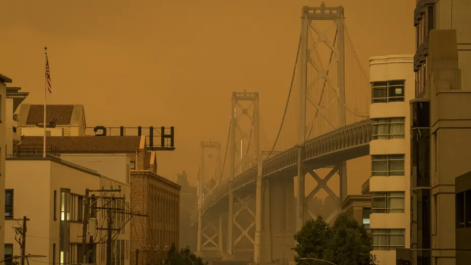Smoke hangs over the Oakland-San Francisco Bay Bridge in San Francisco, California, U.S., on Wednesday, Sept. 9, 2020. Powerful, dry winds are sweeping across Northern California for a third day, driving up the risk of wildfires in a region thats been battered by heat waves, freak lightning storms and dangerously poor air quality from blazes.