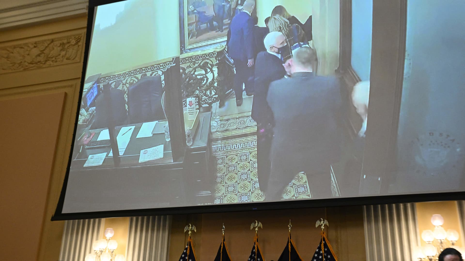Images on a screen show former US Vice President Mike Pence being evacuated on January 6, 2021 from the US Capitol during a hearing of the US House Select Committee to Investigate the January 6 Attack on the US Capitol, on Capitol Hill in Washington, DC, on June 16, 2022.