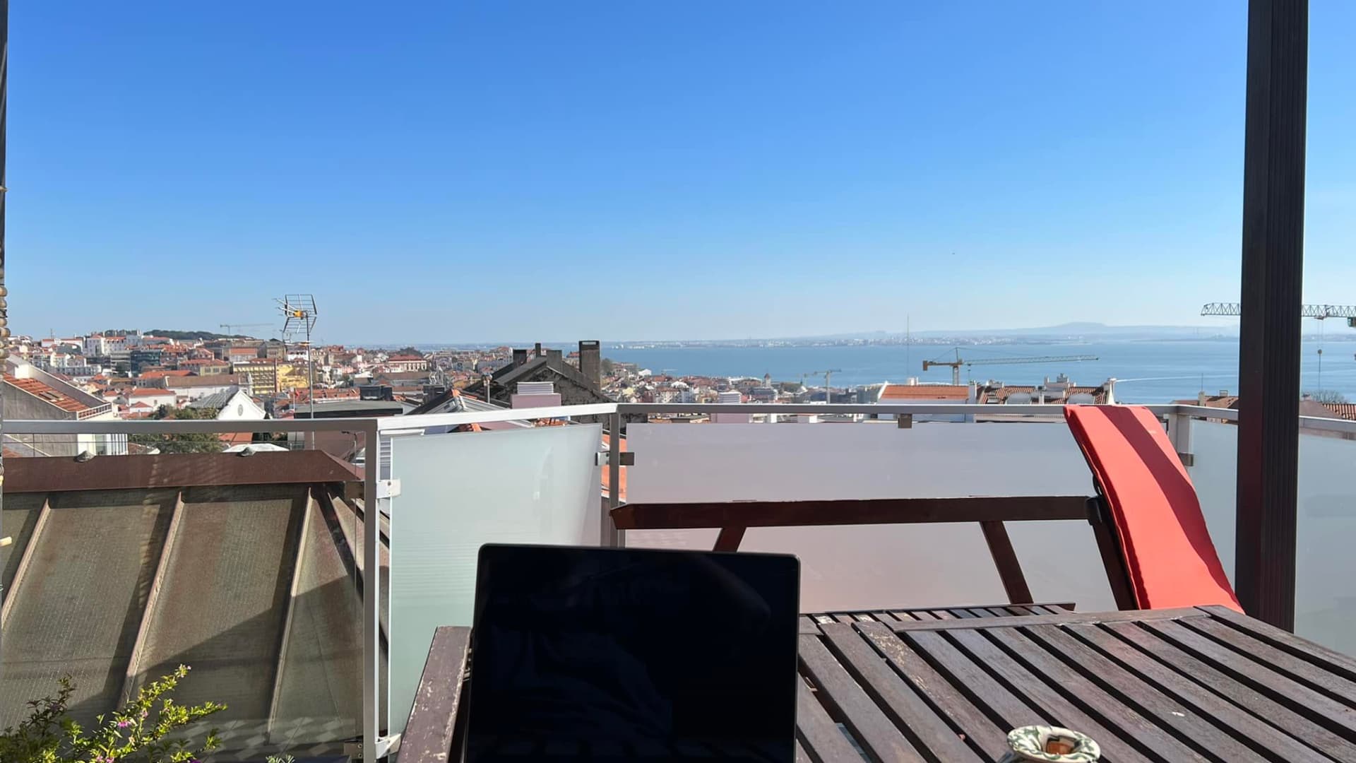 Running an online business allows Kimanzi and his wife to work from anywhere, like this rooftop in Lisbon, Portugal.