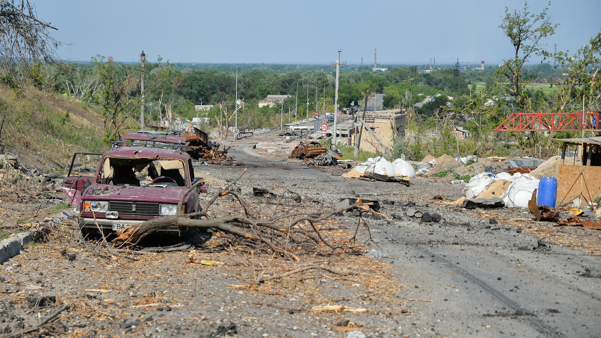 Debris and destroyed cars along a street in Lysychansk.