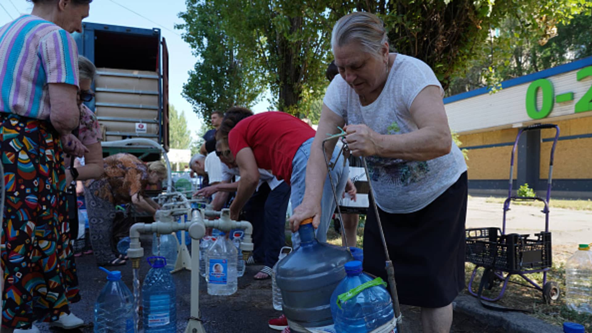 A Ukrainian woman collects water in Mykolaiv, Ukraine, on June 12, 2022.