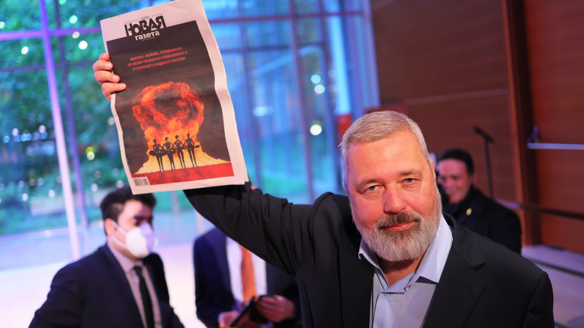 Nobel Peace Prize winner Dmitry Muratov, editor-in-chief of the Russian newspaper Novaya Gazeta, holds up a copy of his paper after the conclusion of bidding during a charity auction at The Times Center on June 20, 2022 in New York City.
