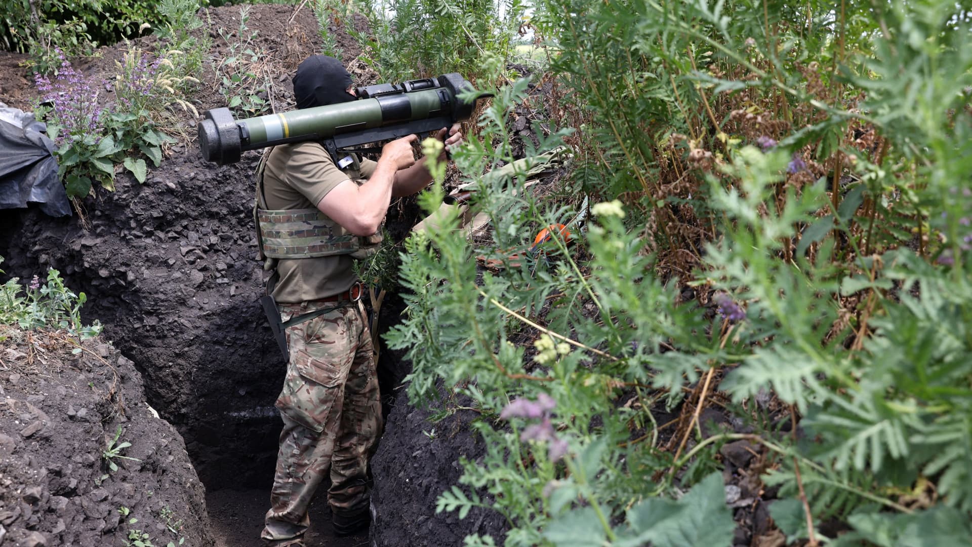A Ukrainian serviceman mans a position in a trench on the front line near Avdiivka in the Donetsk region on June 18, 2022.