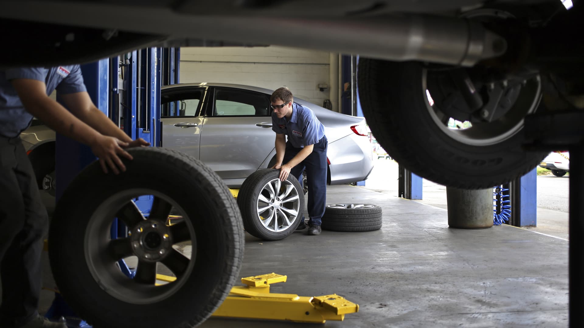 Mechanics perform tire rotations on customer vehicles at a Pep Boys - Manny Moe & Jack service center in Clarksville, Indiana.