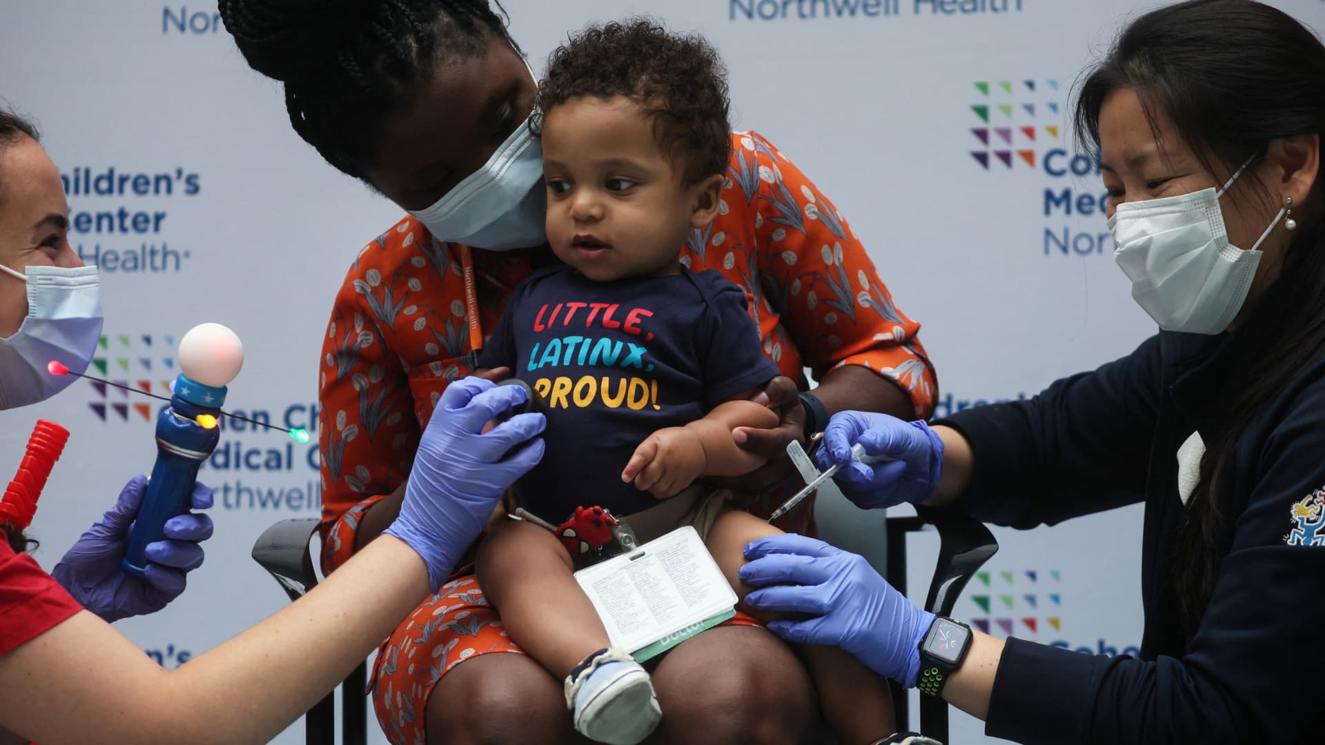 Luca Moore, 11 months, receives a vaccine against the coronavirus disease (COVID-19) while his mother Dr. Danielle Smith holds him at Northwell Health's Cohen Children's Medical Center in New Hyde Park, New York, U.S., June 22, 2022. 