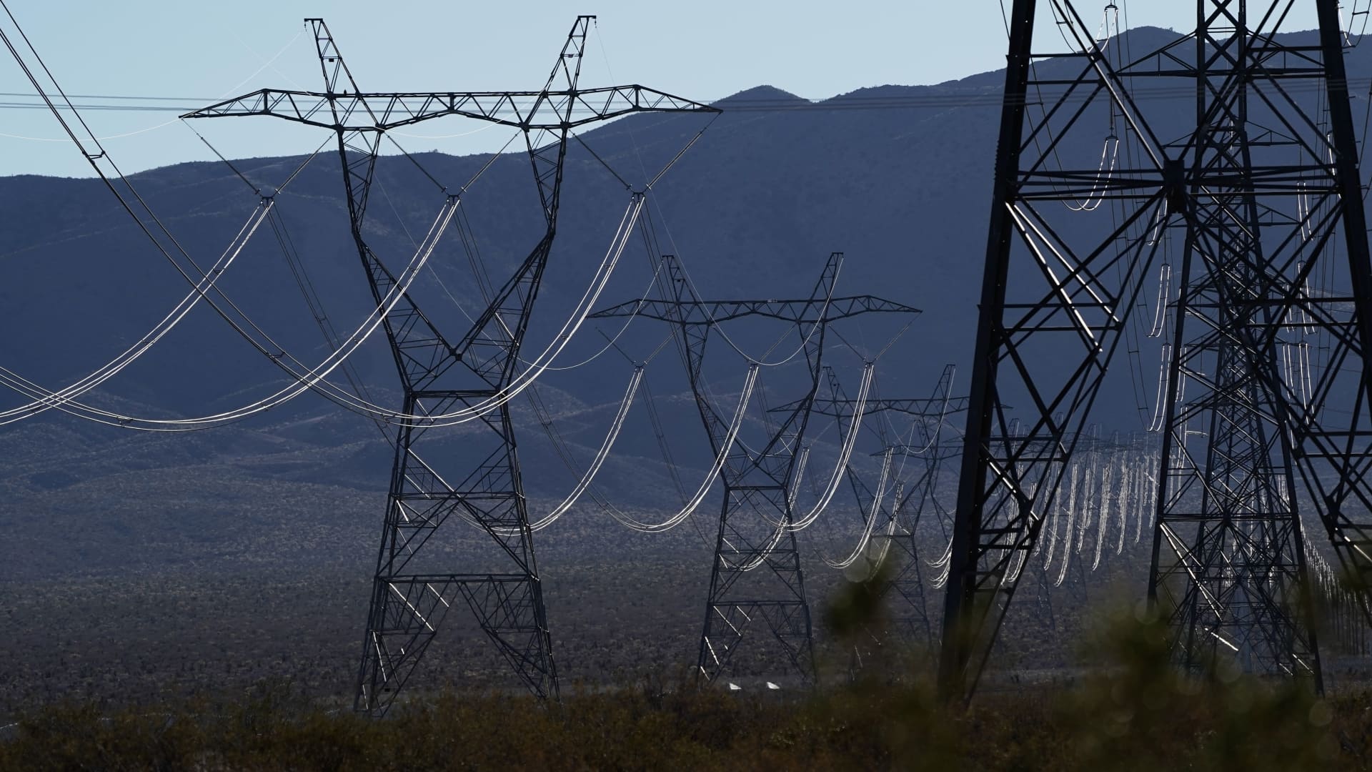 Power lines and transmission towers near the Ivanpah Solar Electric Generating System in the Mojave Desert in San Bernardino County, California, U.S., on Saturday, Feb. 19. 2022. California aims to end greenhouse gas emissions from its electricity grid by 2045.