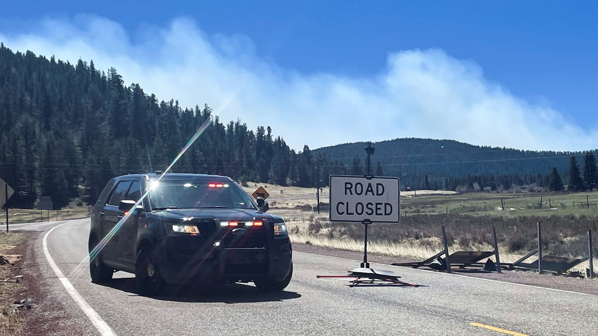 A police roadblock is placed, stopping people entering the area near Holman which is the northern edge of the Hermits Peak Calf Canyon wildfire, near Angostura, New Mexico May 9, 2022. 