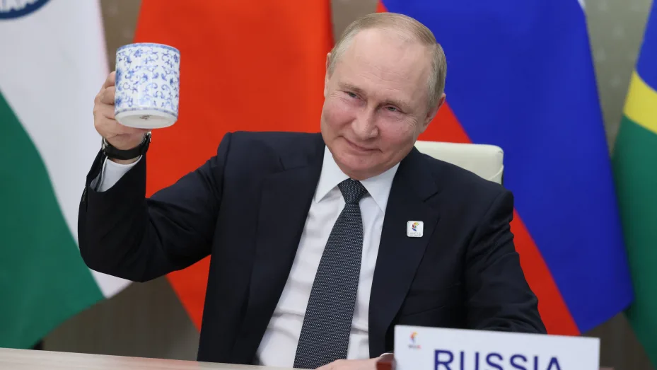 Russian President Vladimir Putin makes a toast as he takes part in the XIV BRICS summit in virtual format via a video call, in Moscow on June 23, 2022.
