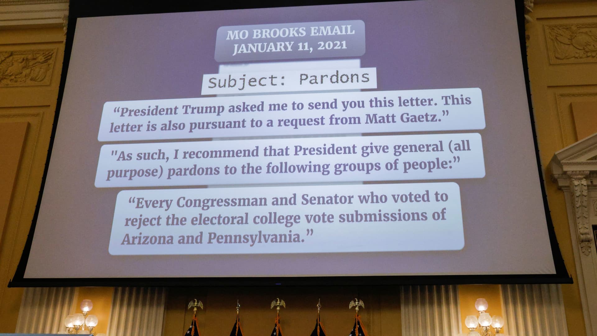 Excerpts from an email by U.S. Rep. Mo Brooks (R-AL) to former White House Chief of Staff Mark Meadows asking for pardons for members of Congress are shown on a screen during the fifth public hearing of the U.S. House Select Committee to Investigate the January 6 Attack on the United States Capitol, on Capitol Hill in Washington, U.S., June 23, 2022.