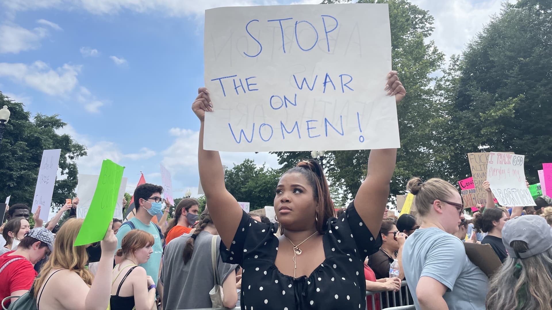 Gabrielle Harris, 30, from New York holds a sign while looking at the Supreme Court building in Washington, D.C., on June 24, 2022.