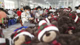 China's exports surged by 16.9% in May from a year ago, two times faster than analysts expected. Pictured here on June 15, 2022, are workers in Jiangsu province making stuffed toy bears for export.