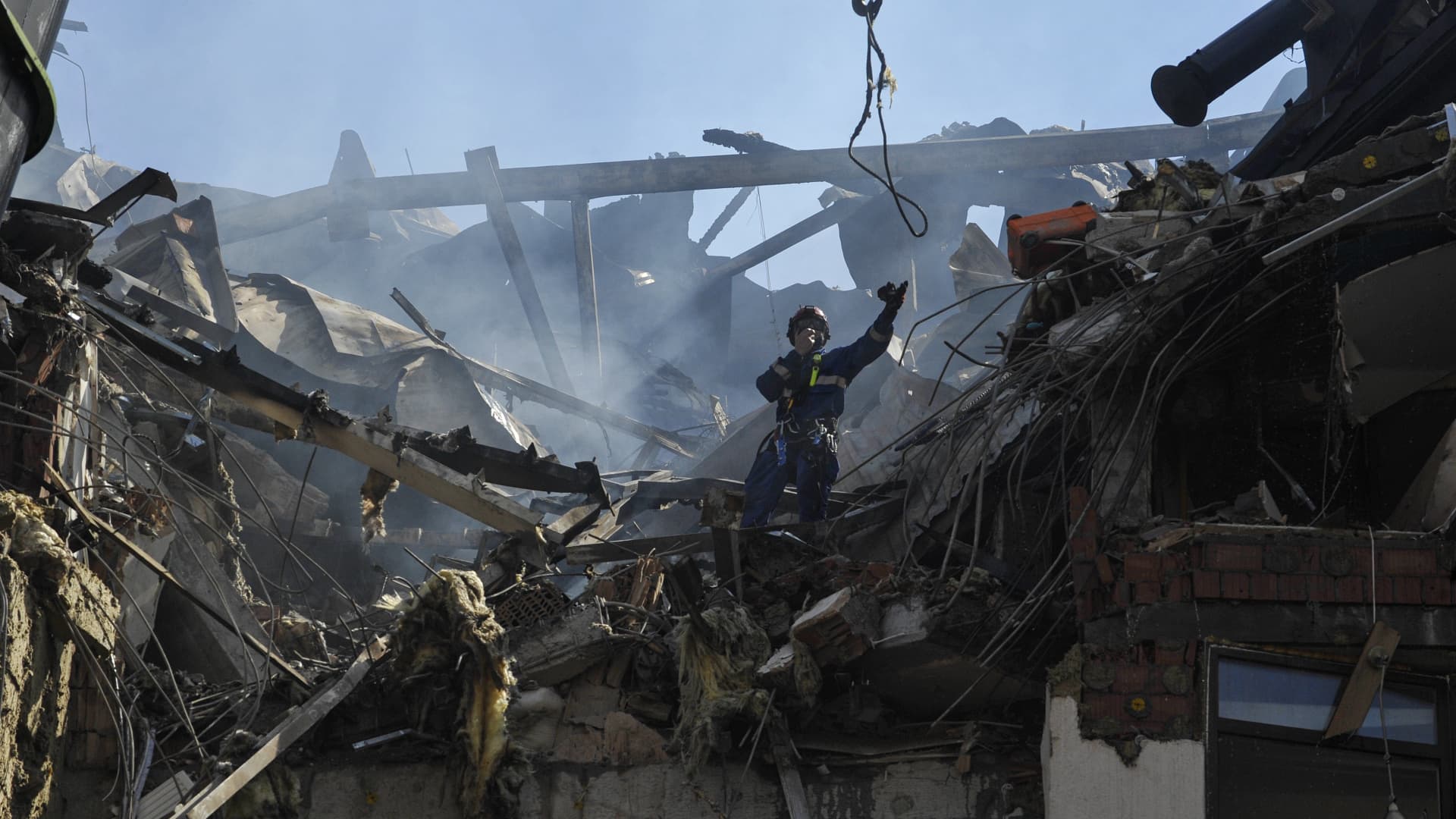 Rescuers work on a damaged residential building in Kyiv. Rockets hit a house and a kindergarten last Friday, leaving six people injured and one dead.