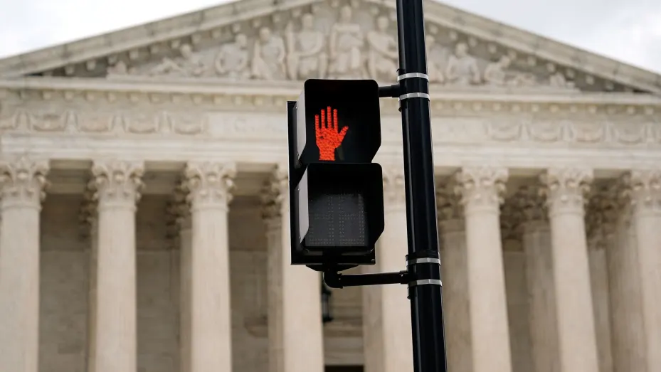 A crosswalk signal is seen outside the U.S. Supreme Court building in Washington, U.S., June 27, 2022. REUTERS/Elizabeth Frantz