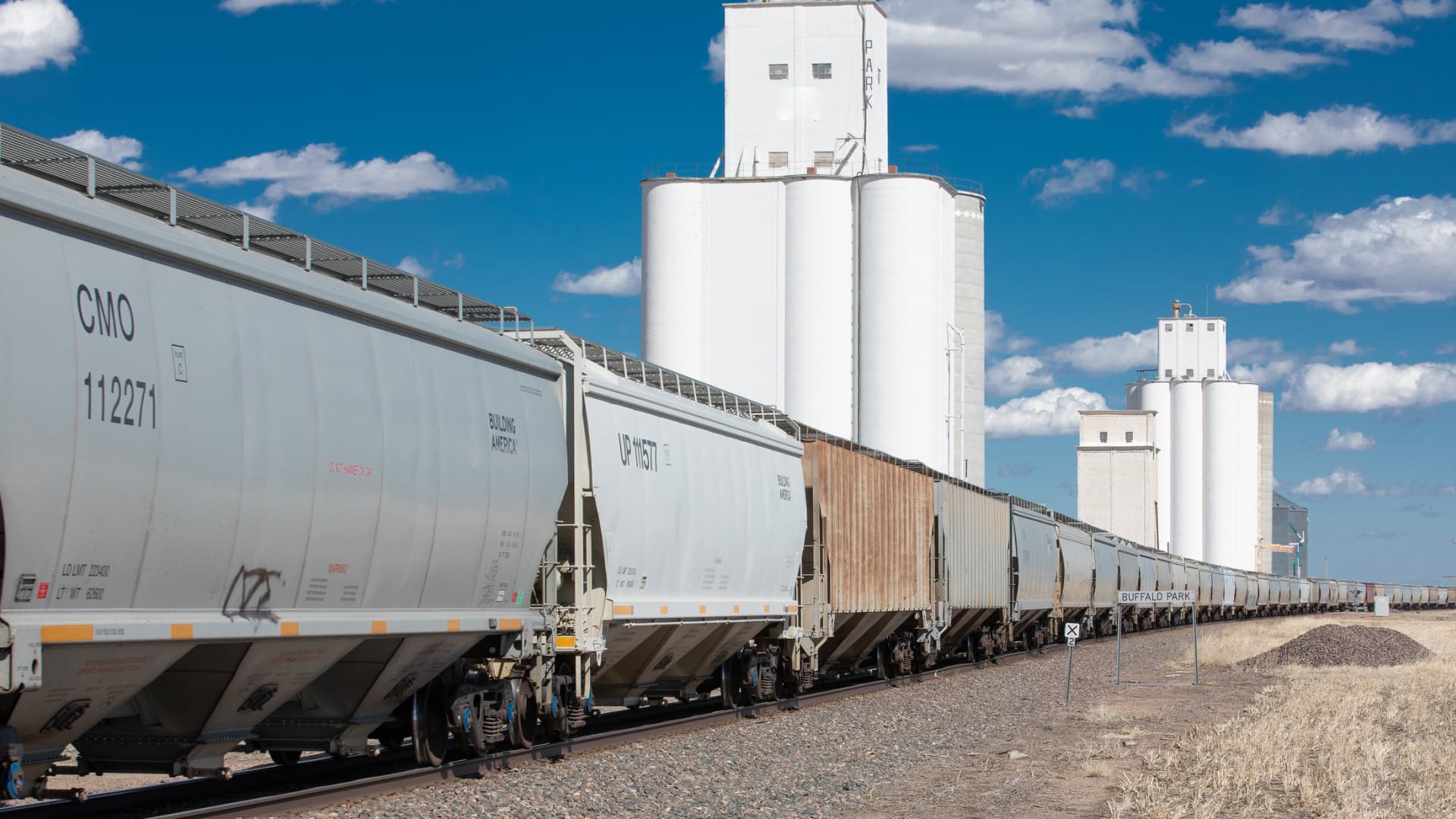 Grain hauling train is stopped at a large Kansas grain silo terminal.