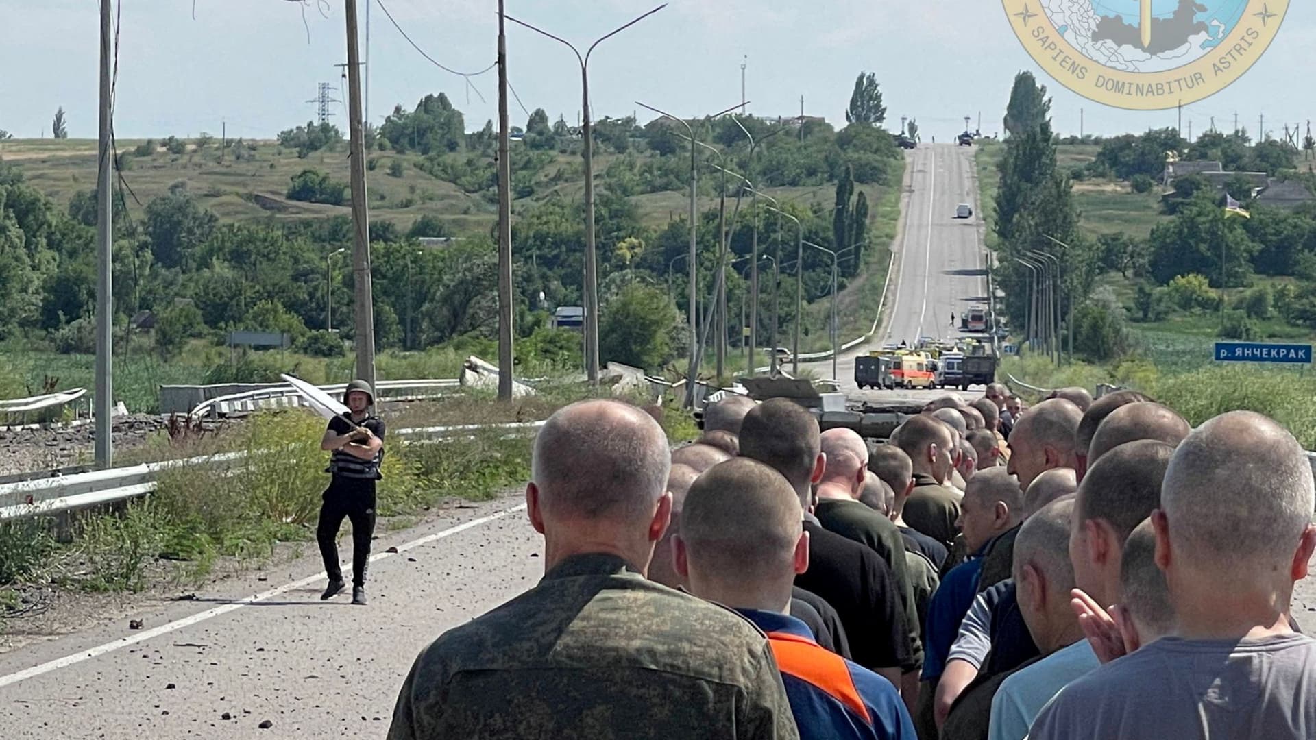Prisoners line up alongside a road during a prisoner exchange, as Russia's attack on Ukraine continues, at a location given as Zaporizhzhia region, Ukraine, in this handout photo released on June 29, 2022.