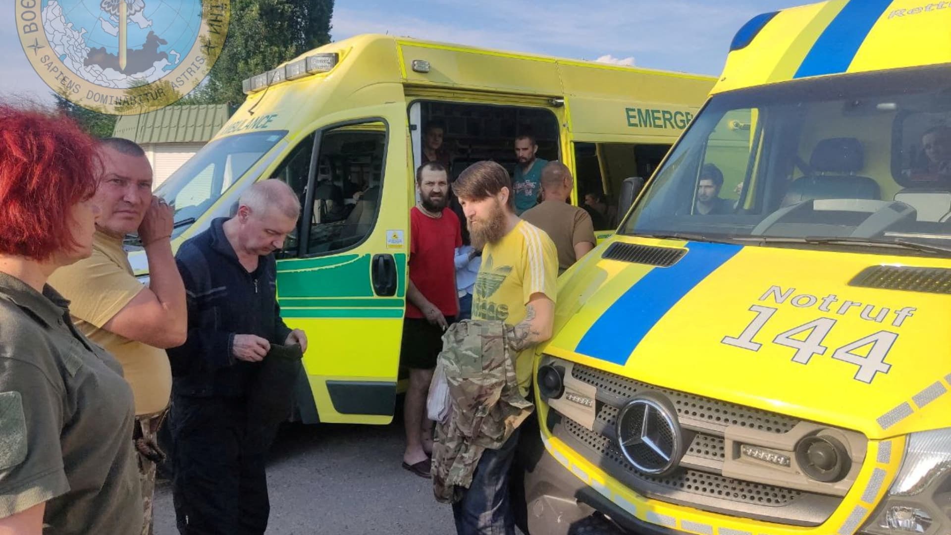Ukrainian soldiers stand next to ambulances as Ukraine carries out an exchange of prisoners, amid Russia's invasion, at a location given as Zaporizhzhia region, Ukraine, in this handout photo released on June 29, 2022.