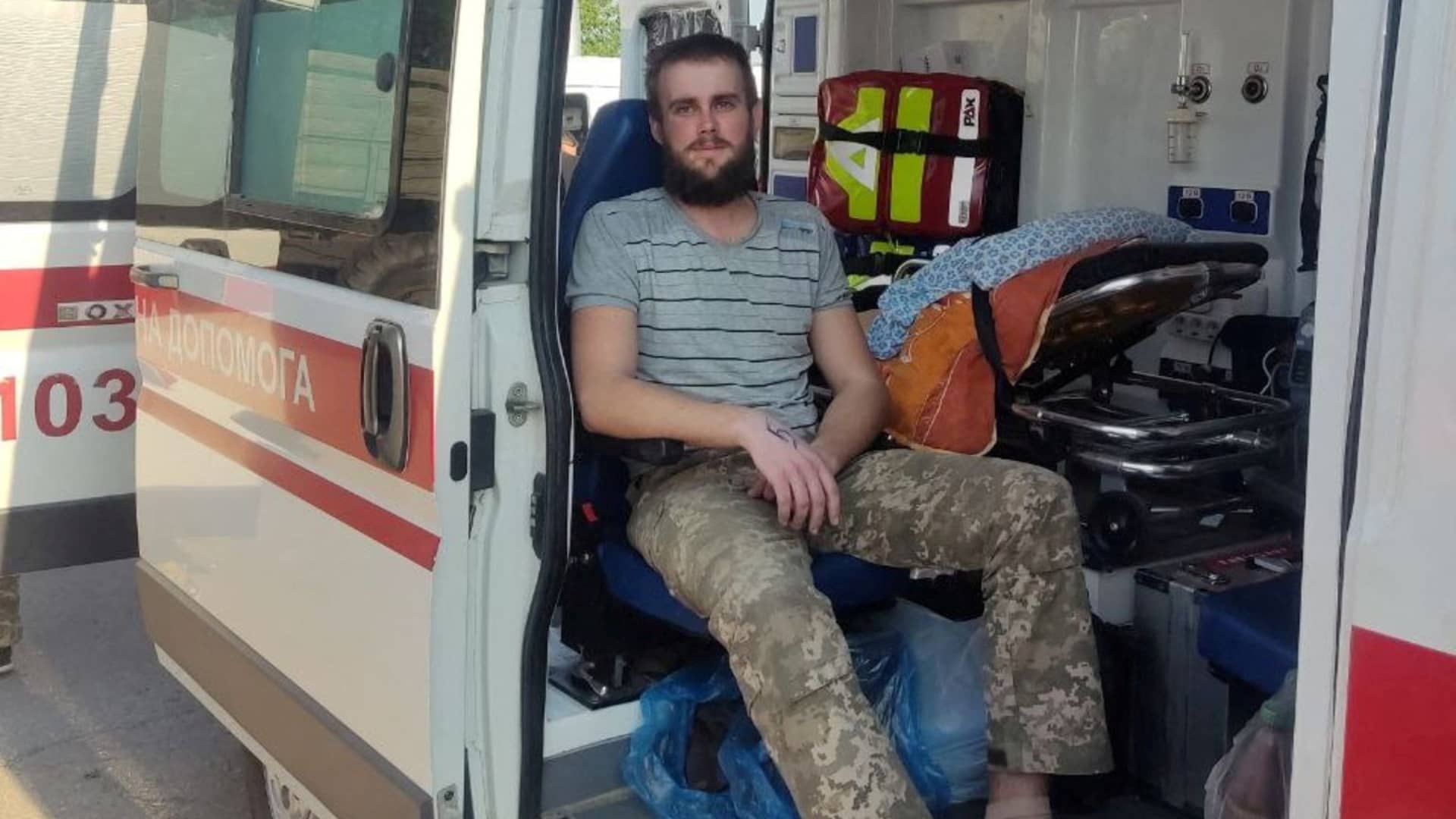 A Ukrainian soldier sits in an ambulance as Ukraine carries out an exchange of prisoners, amid Russia's invasion, at a location given as Zaporizhzhia region, Ukraine, in this handout photo released on June 29, 2022. 