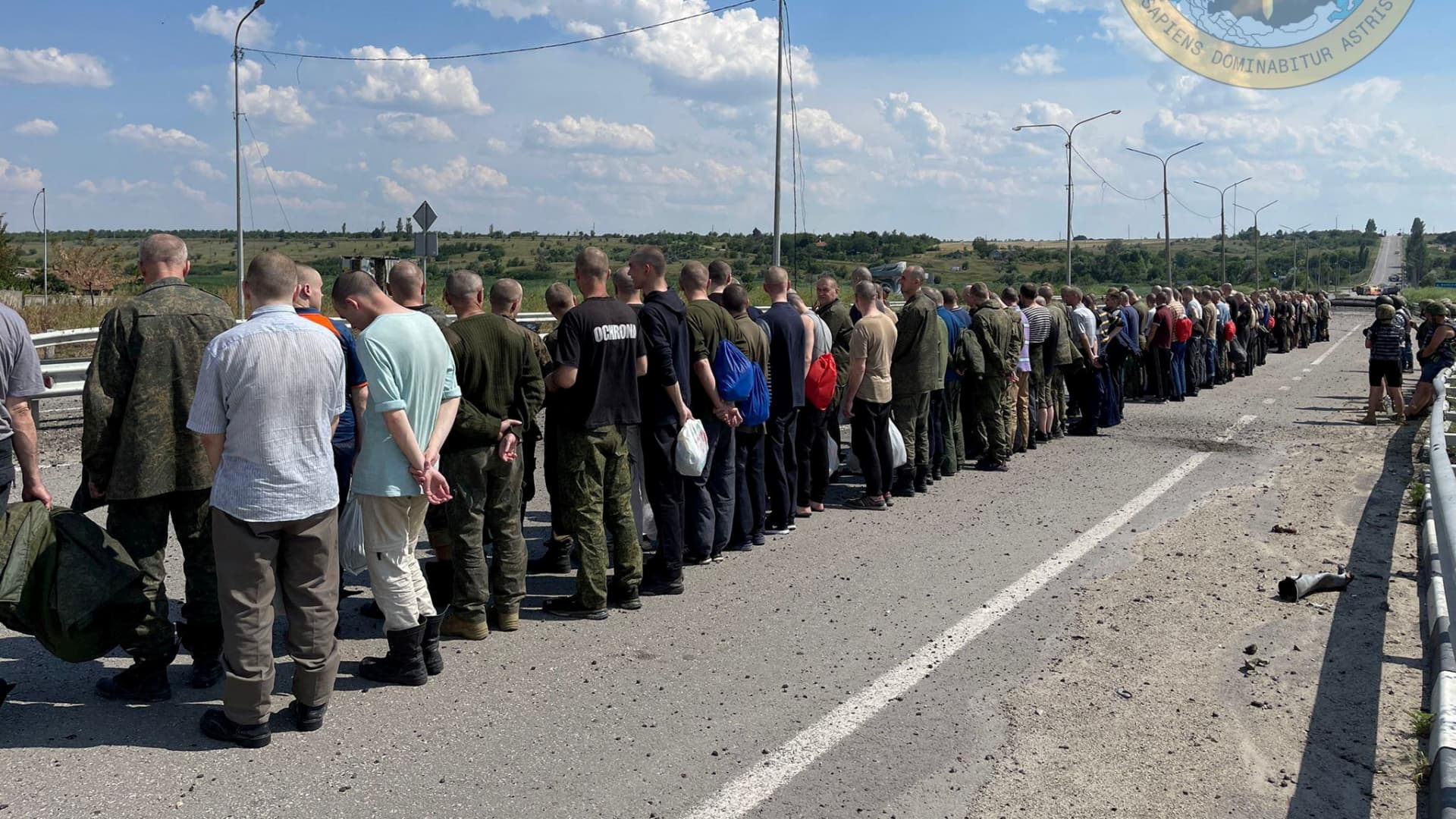 Prisoners line up alongside a road during a prisoner exchange, as Russia's attack on Ukraine continues, at a location given as Zaporizhzhia region, Ukraine, in this handout photo released on June 29, 2022. 