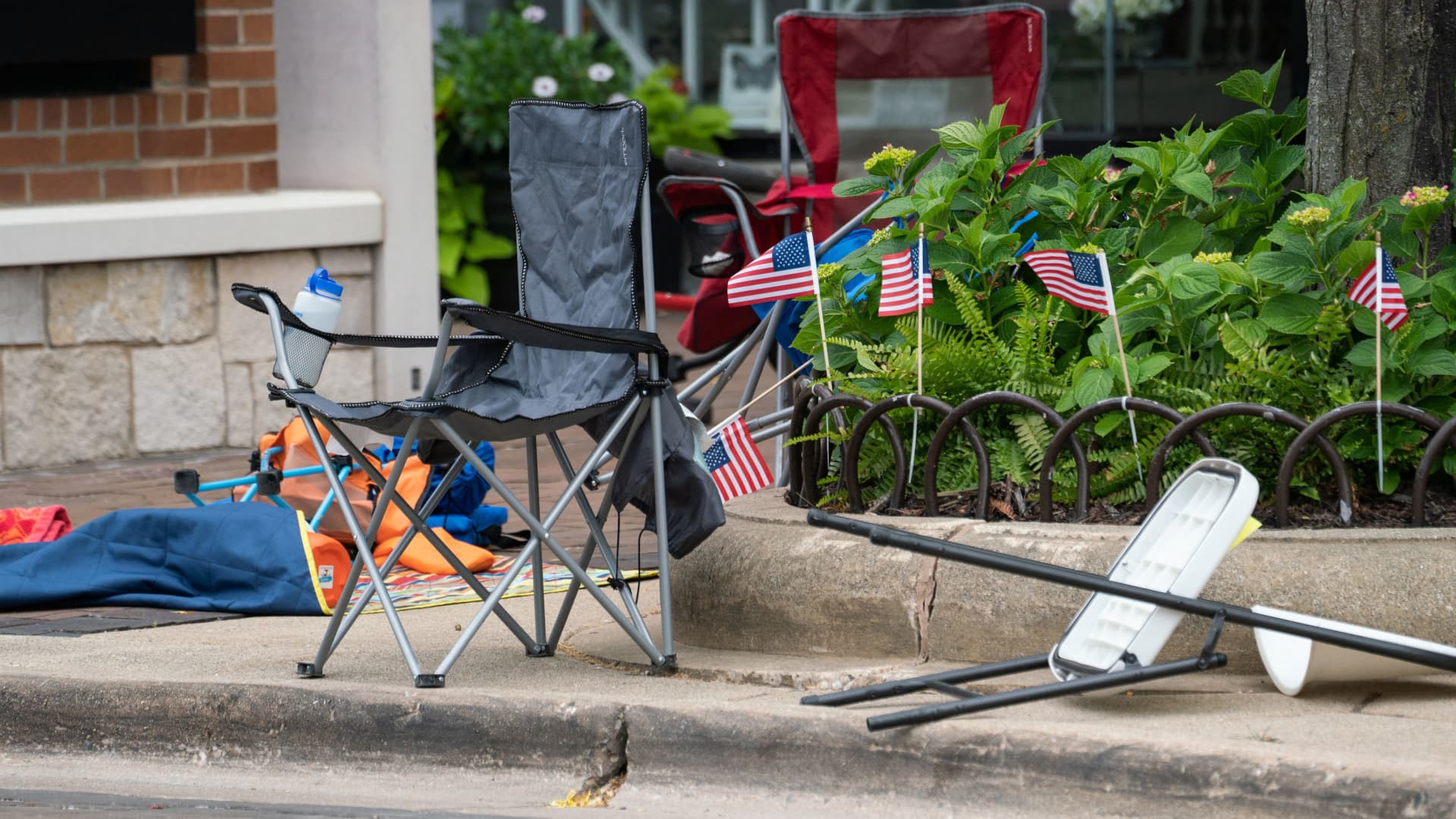 Portable chairs are left behind on Central Avenue after a mass shooting at a Fourth of July parade route in the wealthy Chicago suburb of Highland Park, Illinois, on July 4, 2022.