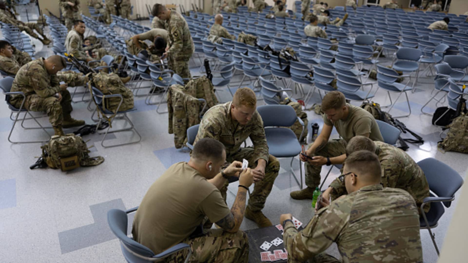 Members of the U.S. Army 2nd Brigade Combat Team await their flight to Europe for deployment on July 7, 2022 in Fort Campbell, Kentucky.