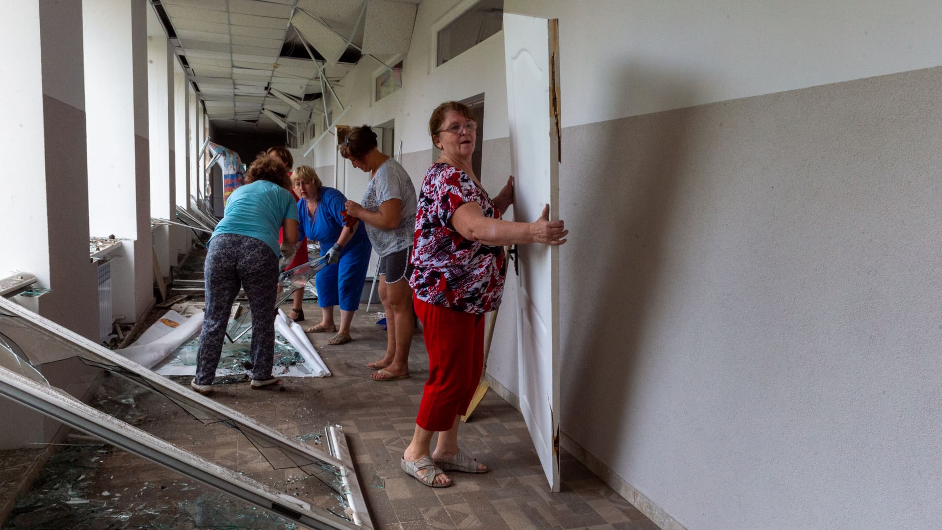 Employees of a boarding school for children with impaired vision are cleaning up the fragments of windows and doors that were shattered as a result of a Russian rocket hitting the yard of the institution in Kharkiv, Ukraine on July 07, 2022.