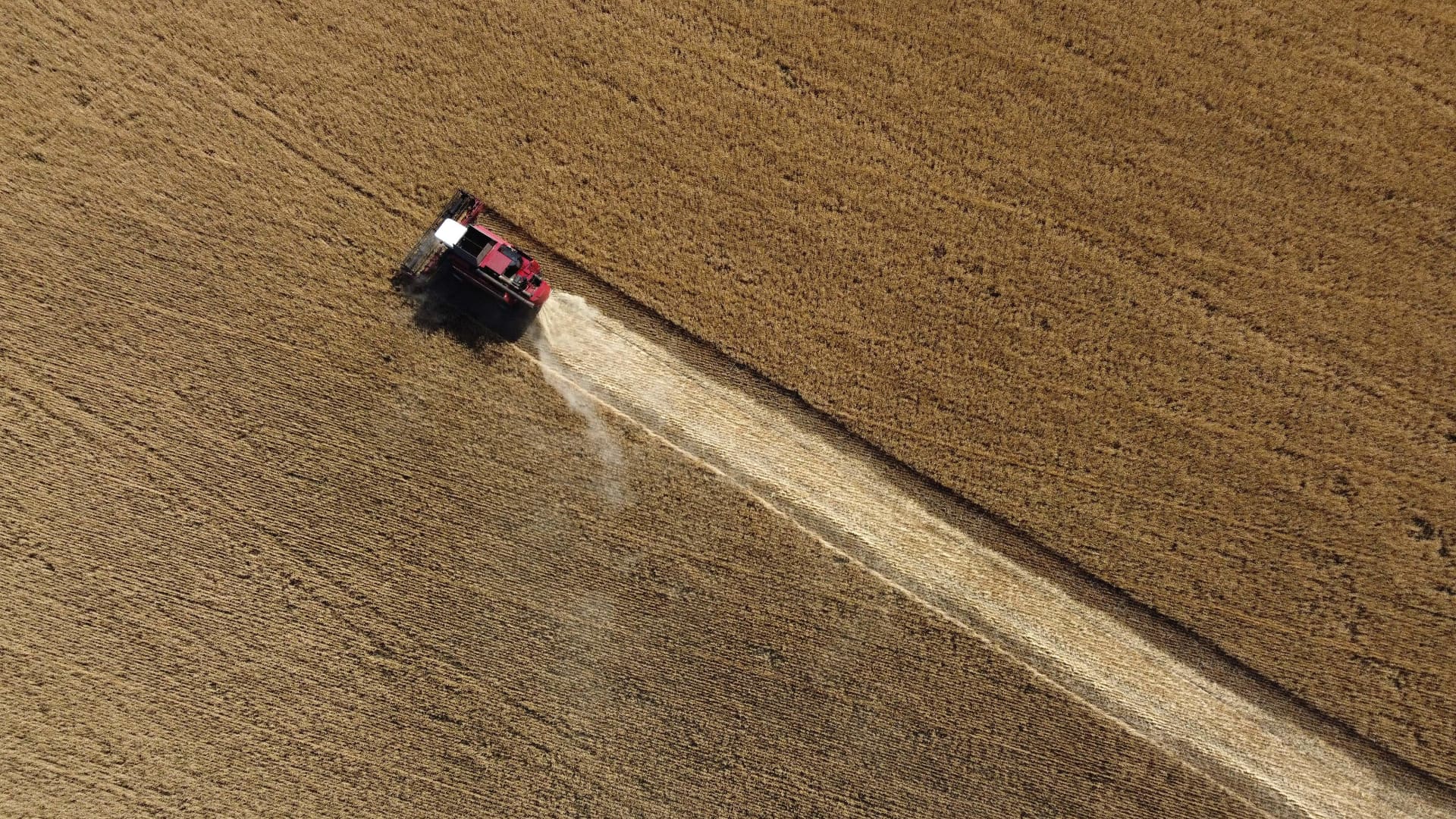 This aereal picture taken on July 7, 2022 shows farmer harvesting wheat near Kramatosk in the Donetsk Oblast, Ukraine. (