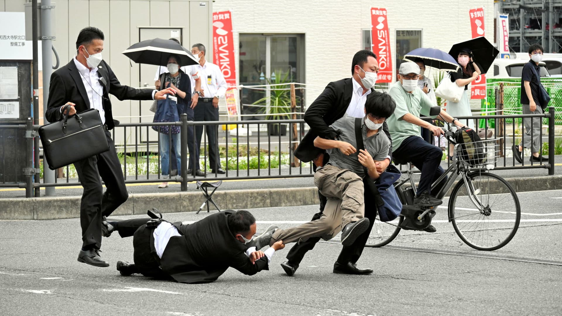 A man, believed to have shot former Japanese Prime Minister Shinzo Abe, is tackled by police officers in Nara, western Japan July 8, 2022 in this photo taken by The Asahi Shimbun. 