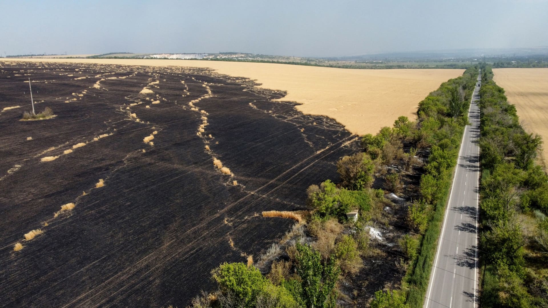 An aerial picture taken on July 8, 2022 in the countryside of Siversk, in Donetsk Oblast, eastern Ukraine, shows wheat plantations burnt following air strike attacks of the Russian army in the region.