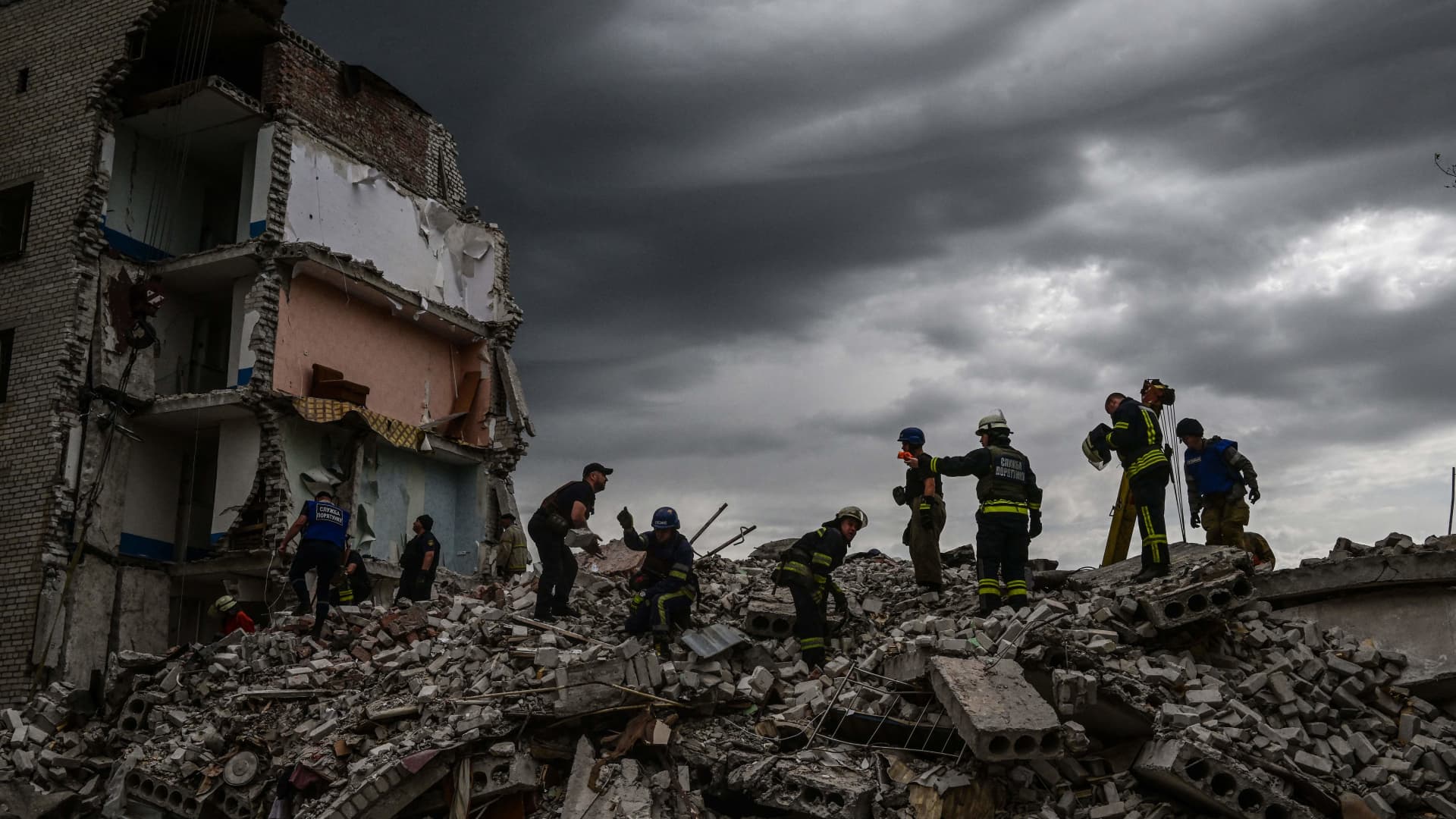 Firefighters and members look for survivors after the Russian missile strike on the apartment block in Chasiv Yar.
