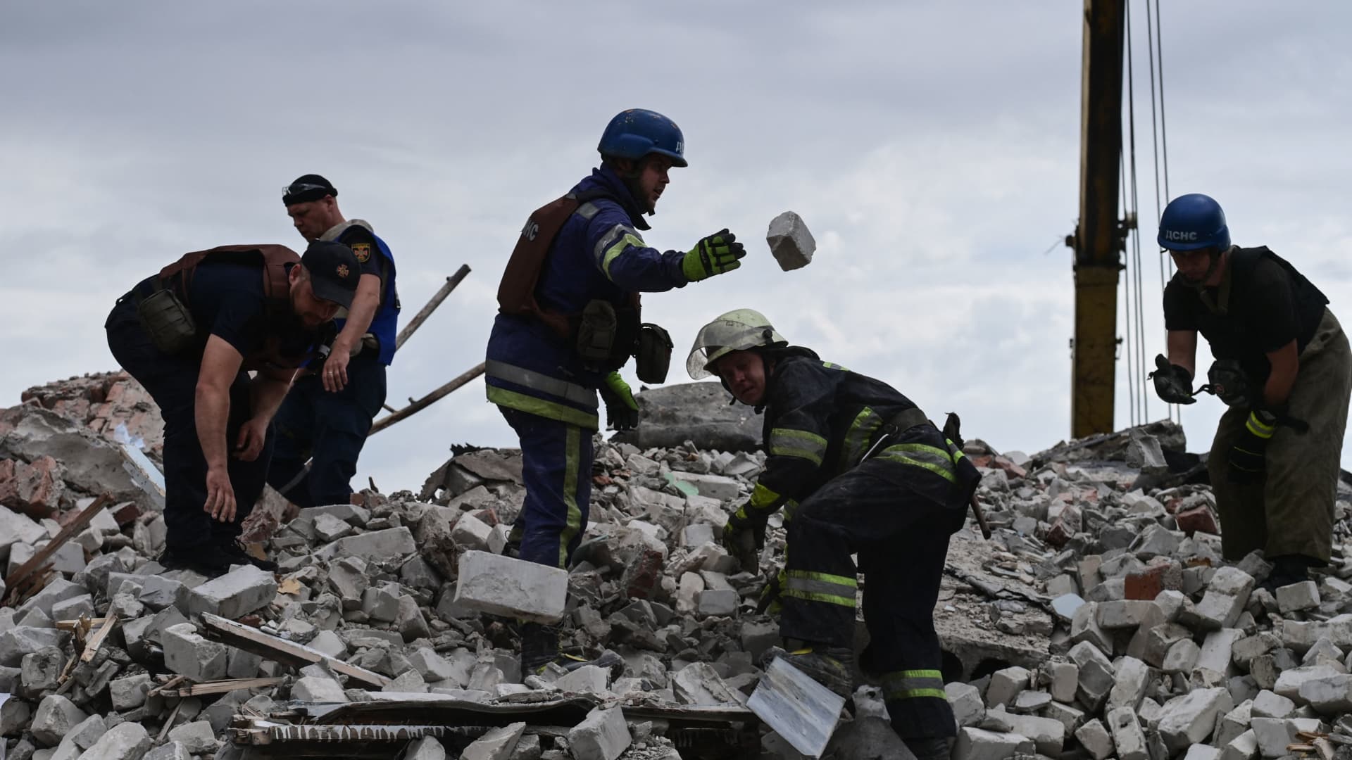 Rescuers clear the scene after a five-storey residential building was struck in Chasiv Yar, Bakhmut District, eastern Ukraine, on July 10, 2022.