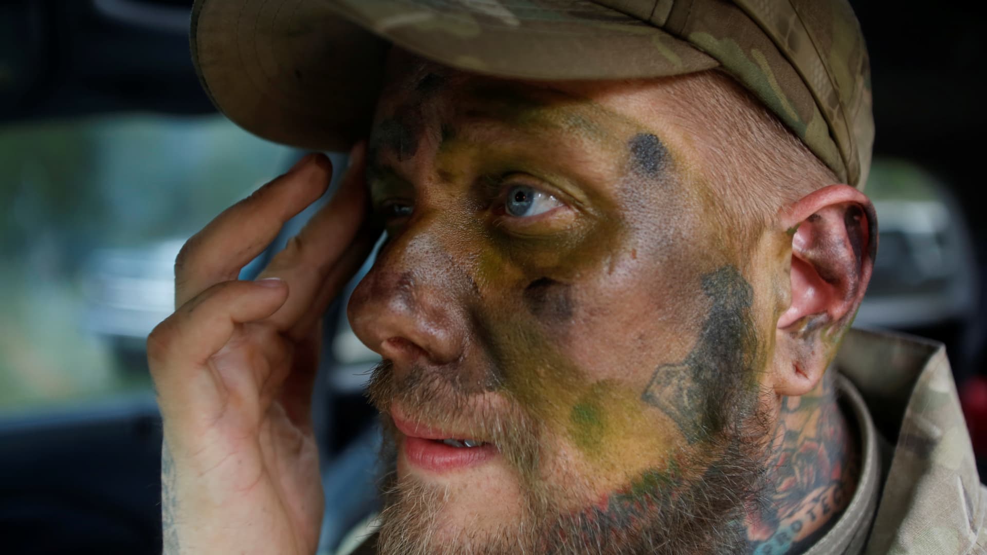 Jason Van Tatenhove, a member of the Oath Keepers, puts on camouflage face paint during a tactical training session in western Montana, U.S. April 30, 2016.