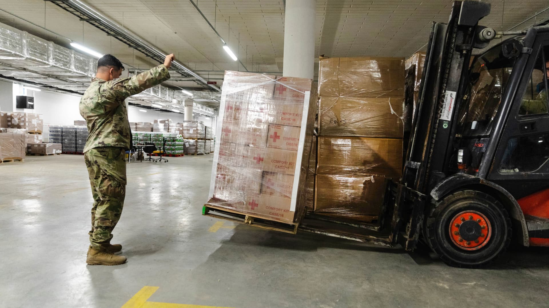Paratroopers assigned to the 82nd Airborne Division, assist with unloading humanitarian goods in support of the United States Agency for International Development (USAID) in preparation of potential evacuees from Ukraine at the G2A Arena in Jasionka, Poland, on Feb. 25, 2022.