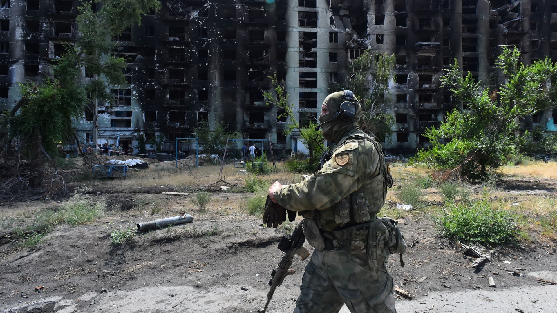 A Russian serviceman patrols a destroyed residential area in the captured Ukrainian city of Severodonetsk on July 12, 2022.