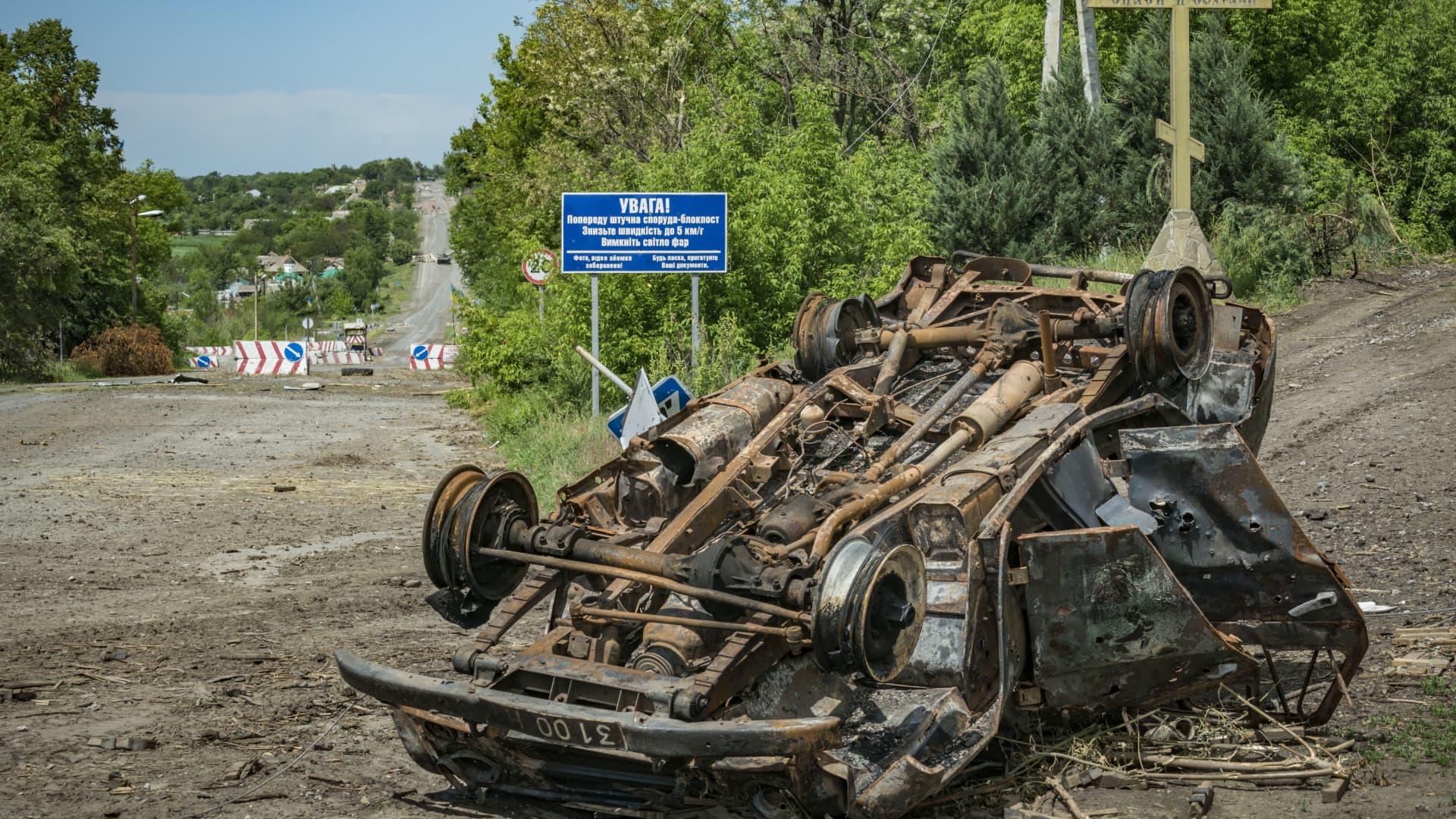 A car destroyed by Russian shelling at the entrance of the village of Dolyna in the Donbas. Dolyna is near the front line between Russian and Ukrainian armies.