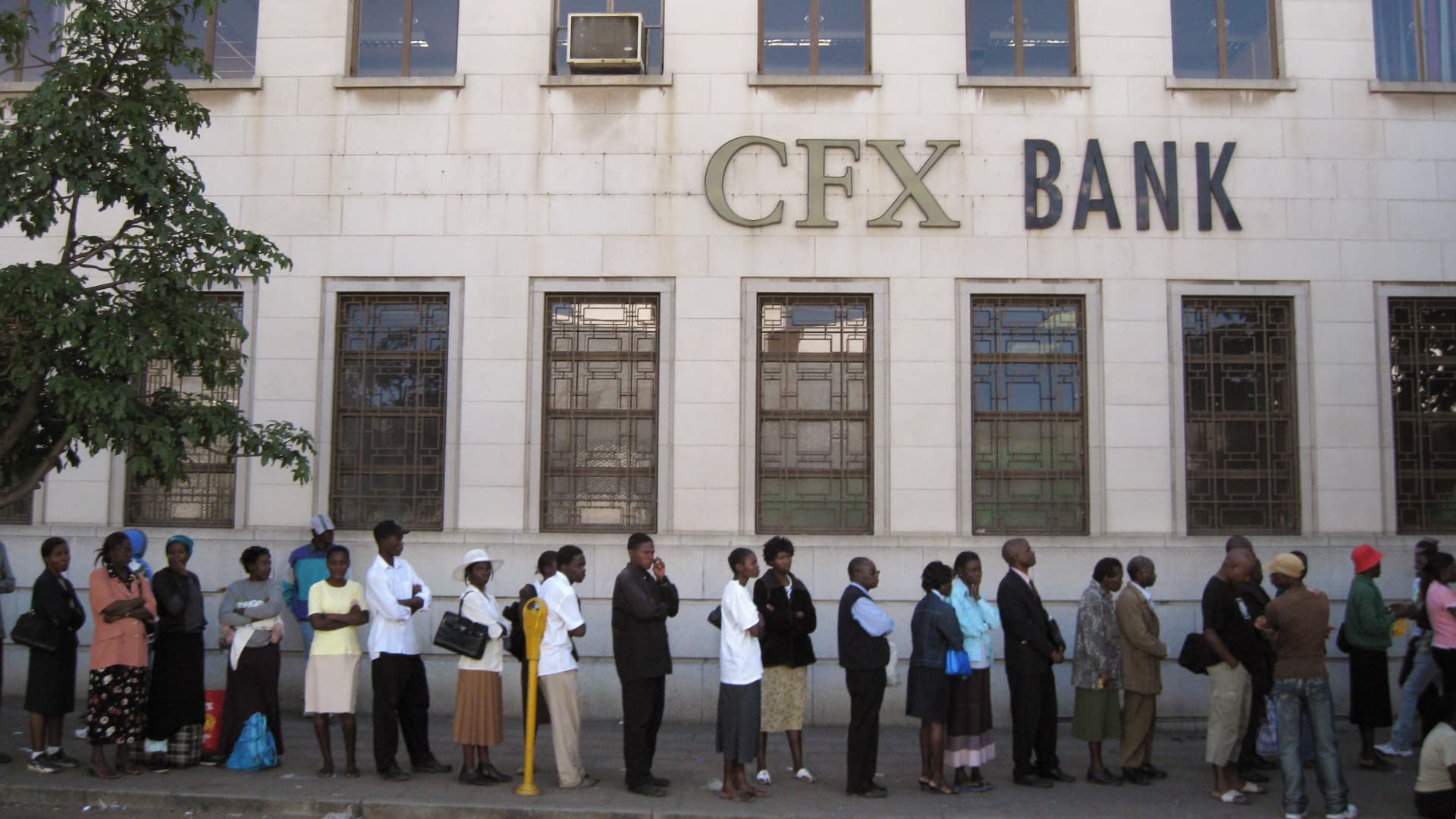 Zimbabweans queue to withdraw money from a bank on June 21, 2008 in Bulawayo, Zimbabwe.