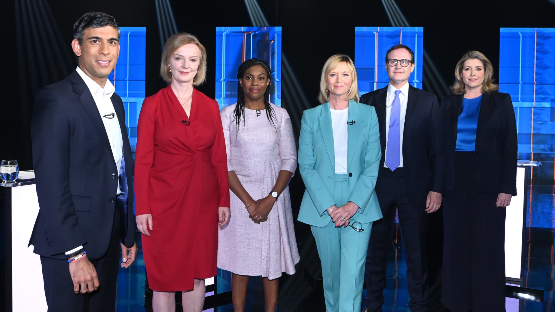 In this handout image provided by ITV, Conservative leadership candidates Rishi Sunak, Liz Truss, Kemi Badenoch, Tom Tugendhat and Penny Mordaunt stand with presenter Julie Etchingham (in the light blue suit) during Britain's Next Prime Minister: The ITV Debate at Riverside Studios on July 17, 2022 in London, England.